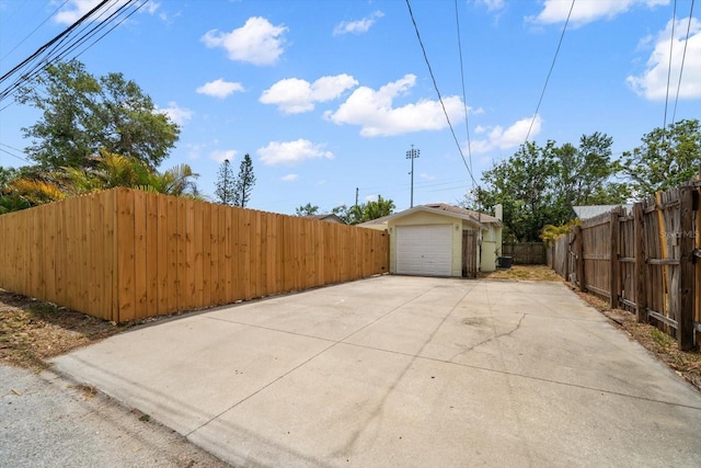2585 9th Ave N, Saint Petersburg, FL 33713 - view of patio with concrete driveway, fence, and a garage