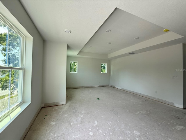 5235 9th Ave N, Saint Petersburg, FL 33710 - unfurnished room featuring a raised ceiling, baseboards, and a wealth of natural light