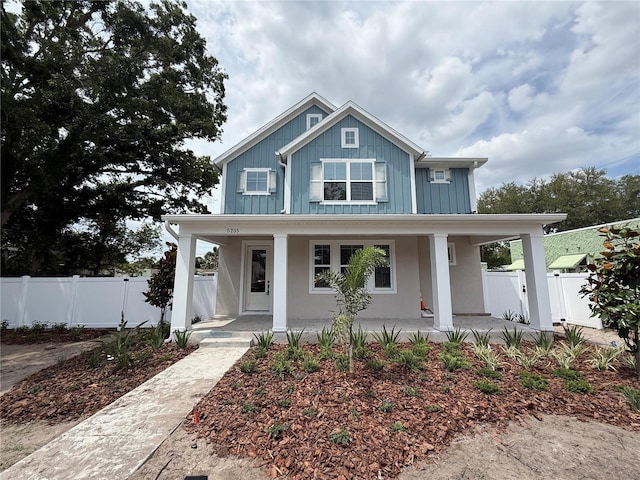 5235 9th Ave N, Saint Petersburg, FL 33710 - view of front of home with fence, board and batten siding, and a porch