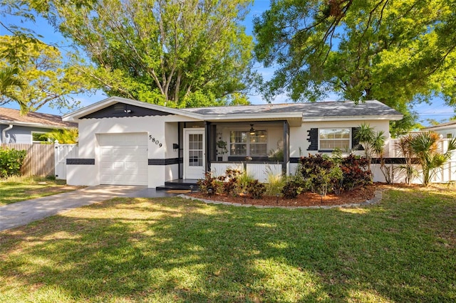 ranch-style house with concrete driveway, stucco siding, fence, an attached garage, and a front lawn