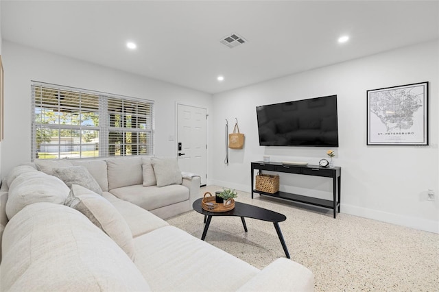 living area with baseboards, visible vents, recessed lighting, and speckled floor