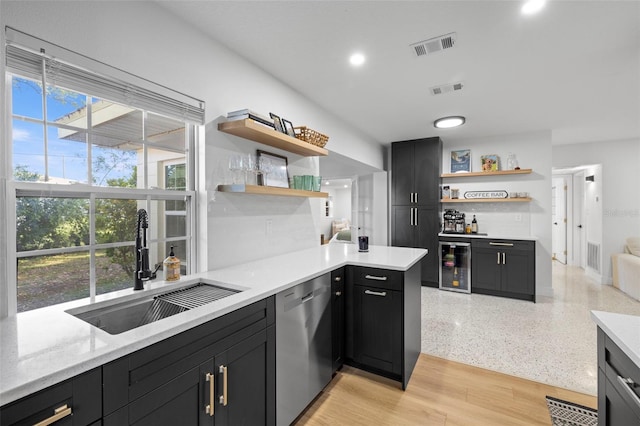 kitchen with dishwasher, a sink, a healthy amount of sunlight, and open shelves