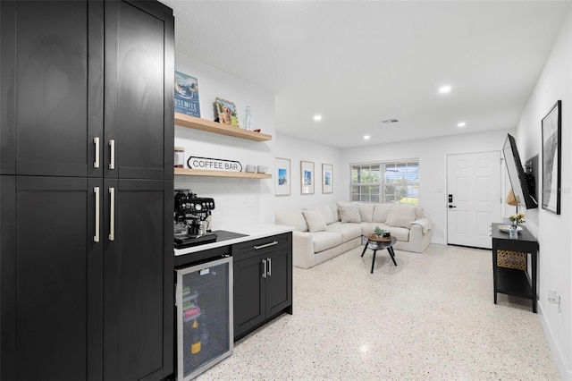 living area with visible vents, baseboards, wine cooler, and recessed lighting
