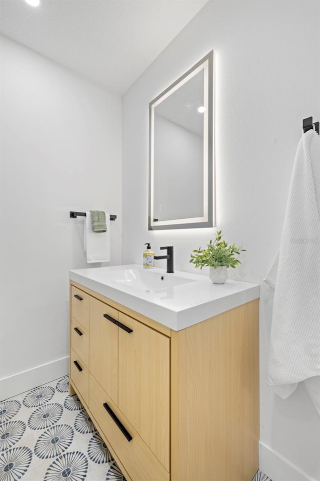 bathroom with vanity and baseboards
