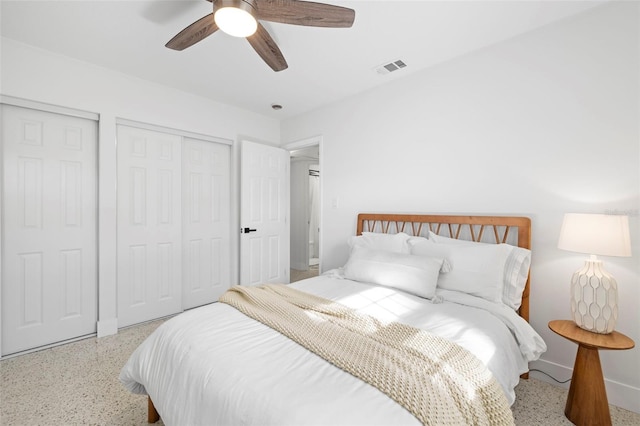 bedroom with speckled floor, baseboards, ceiling fan, and visible vents