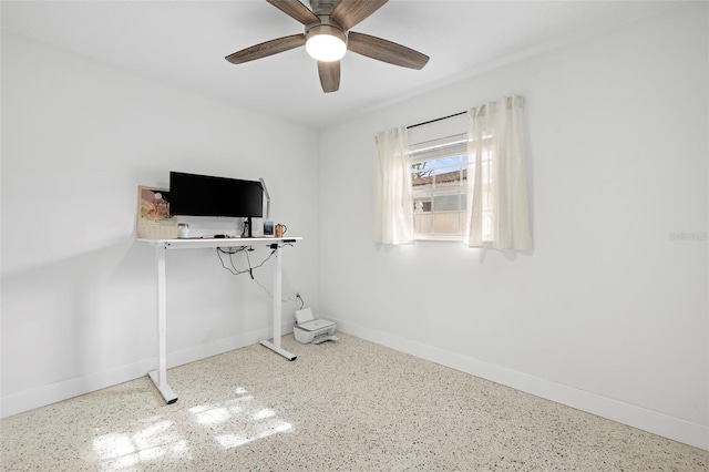 unfurnished office featuring speckled floor, baseboards, and ceiling fan