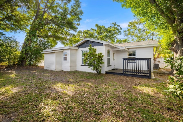 rear view of house featuring central AC unit, a wooden deck, and fence