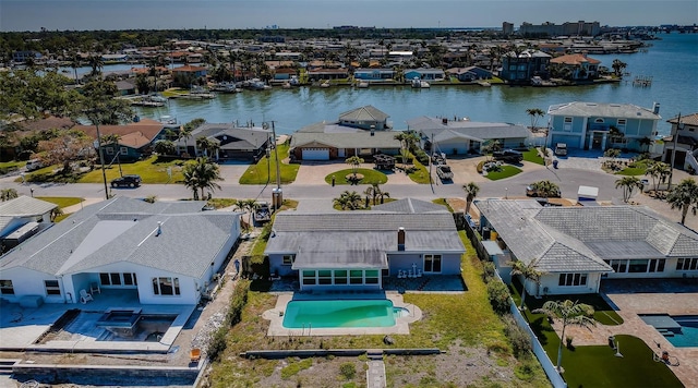drone / aerial view featuring a residential view and a water view