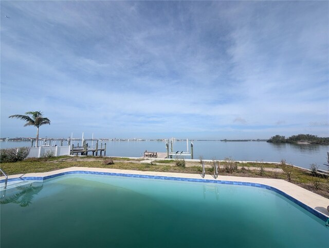 pool with boat lift, a water view, and a boat dock
