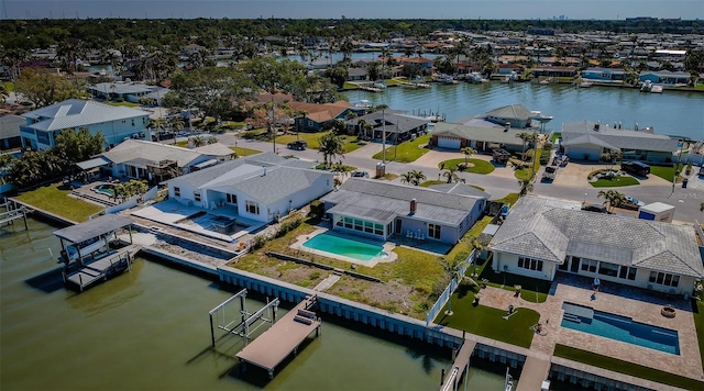 birds eye view of property with a residential view and a water view
