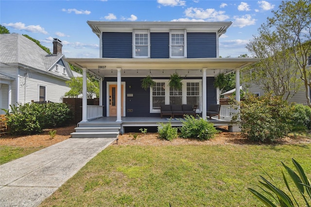 view of front of home with a front lawn and a porch