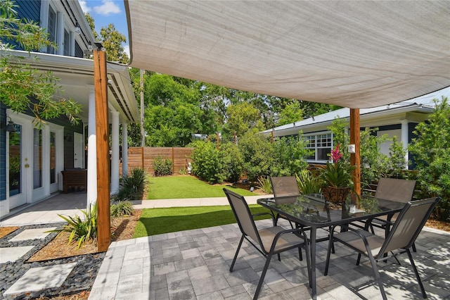 view of patio featuring fence and outdoor dining area