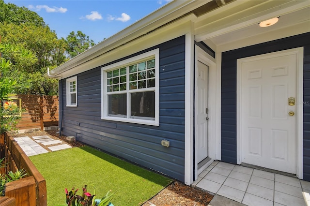 property entrance with a yard