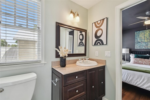 bathroom featuring toilet, vanity, ensuite bathroom, and ceiling fan