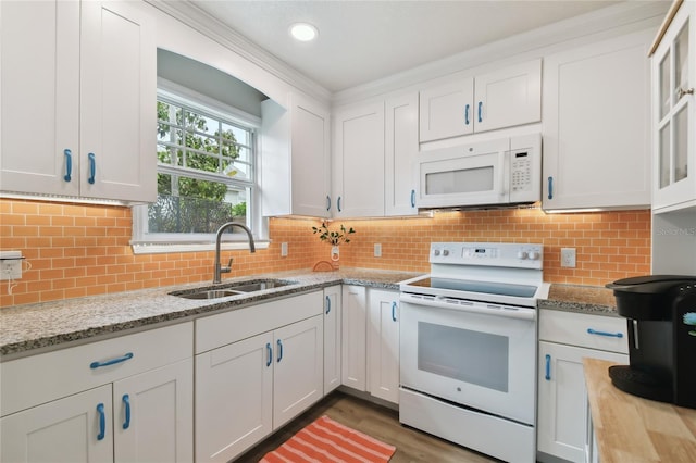 kitchen with white cabinetry, a sink, backsplash, and white appliances