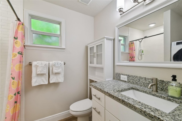 full bath with vanity, toilet, washer / dryer, visible vents, and curtained shower