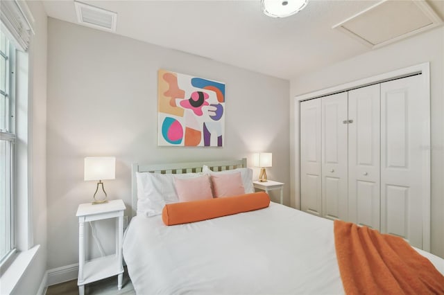 bedroom featuring baseboards, a closet, and visible vents