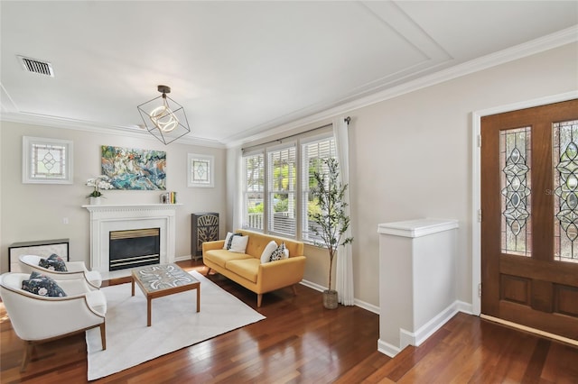 entrance foyer featuring wood finished floors, crown molding, and visible vents