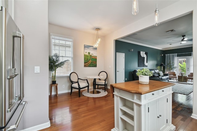 kitchen featuring dark wood-style flooring, high end fridge, wood counters, ceiling fan, and white cabinets
