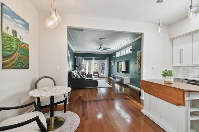 hallway featuring dark wood-style floors, crown molding, and baseboards