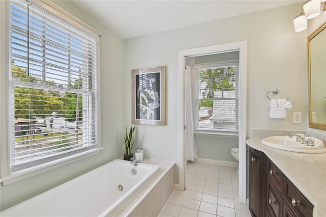 full bathroom featuring vanity, toilet, baseboards, tile patterned floors, and tiled tub