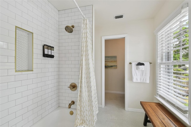 full bathroom with baseboards, visible vents, tile patterned flooring, and shower / tub combo