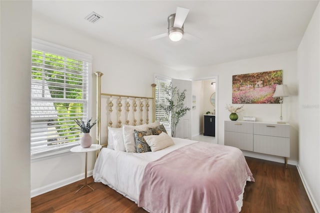 bedroom with baseboards, visible vents, a ceiling fan, and dark wood-style flooring