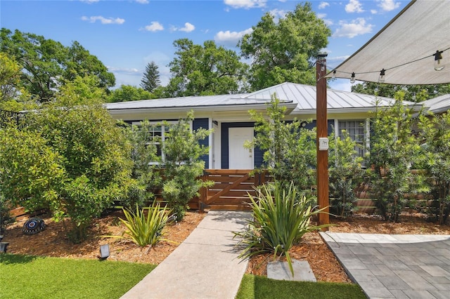 view of front of property featuring metal roof and a standing seam roof