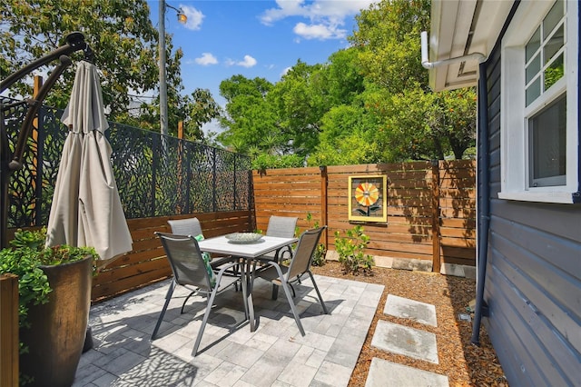 view of patio / terrace featuring fence and outdoor dining space