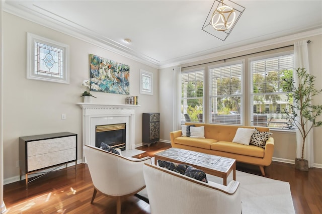 living room featuring a fireplace with flush hearth, baseboards, wood finished floors, and ornamental molding