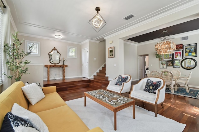 living area with stairs, crown molding, a chandelier, wood finished floors, and visible vents