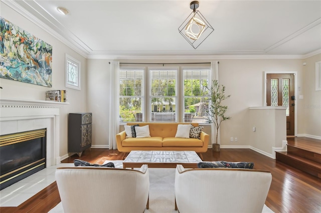 living area with a fireplace, wood finished floors, and ornamental molding