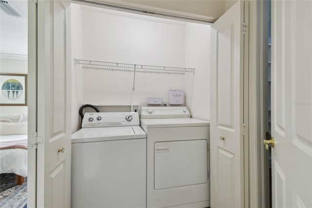 laundry area featuring washer and clothes dryer, laundry area, and visible vents