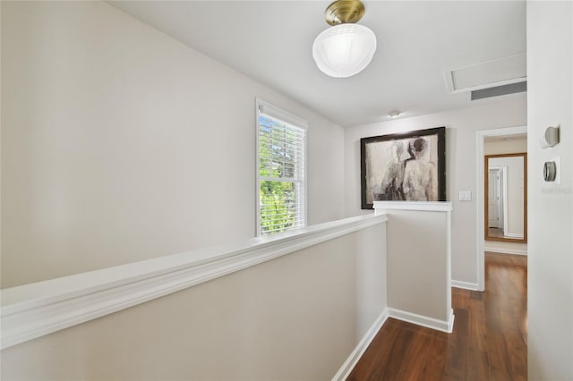 hallway featuring dark wood-style floors and baseboards