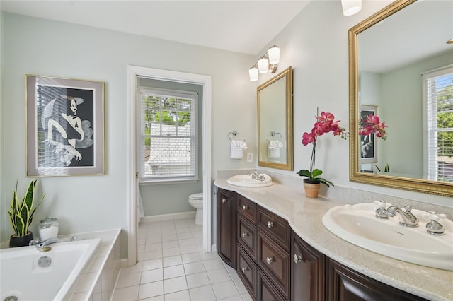 full bathroom featuring double vanity, tiled bath, a sink, and toilet