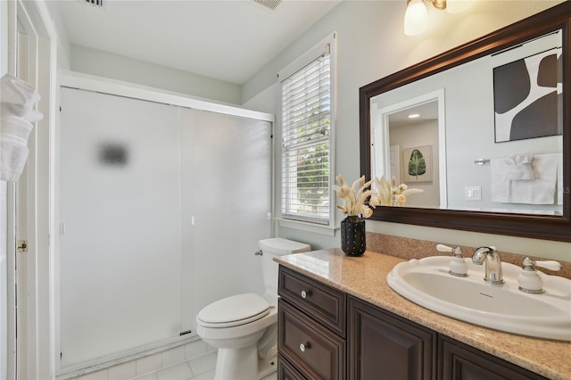 bathroom with toilet, a stall shower, tile patterned flooring, and vanity
