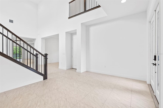 30900 Spruceberry Ct, Wesley Chapel, FL 33543 - foyer entrance featuring a towering ceiling, baseboards, visible vents, and stairway