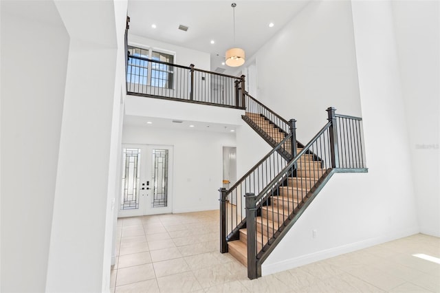 30900 Spruceberry Ct, Wesley Chapel, FL 33543 - staircase with recessed lighting, tile patterned flooring, a towering ceiling, and visible vents