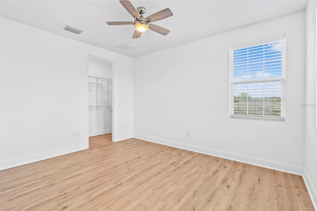 30900 Spruceberry Ct, Wesley Chapel, FL 33543 - unfurnished bedroom with a closet, light wood finished floors, visible vents, and baseboards