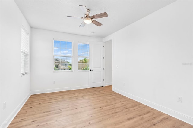 30900 Spruceberry Ct, Wesley Chapel, FL 33543 - spare room featuring ceiling fan, light wood-style floors, and baseboards