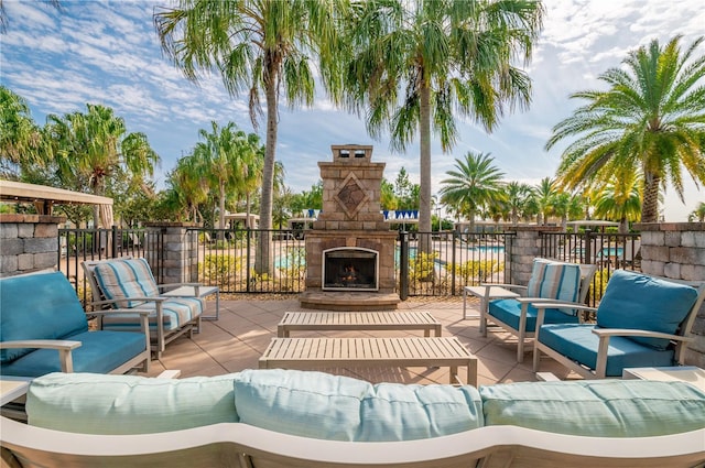 30900 Spruceberry Ct, Wesley Chapel, FL 33543 - view of patio / terrace featuring an outdoor living space with a fireplace and fence