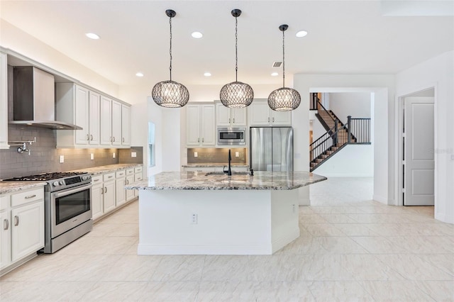 30900 Spruceberry Ct, Wesley Chapel, FL 33543 - kitchen featuring decorative backsplash, appliances with stainless steel finishes, a sink, and wall chimney exhaust hood
