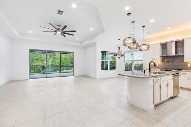30900 Spruceberry Ct, Wesley Chapel, FL 33543 - kitchen featuring a sink, open floor plan, wall chimney exhaust hood, and a healthy amount of sunlight