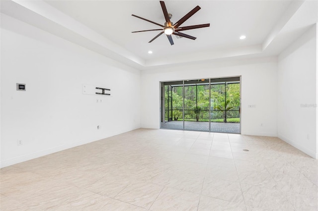 30900 Spruceberry Ct, Wesley Chapel, FL 33543 - unfurnished room with a raised ceiling, baseboards, a ceiling fan, and recessed lighting