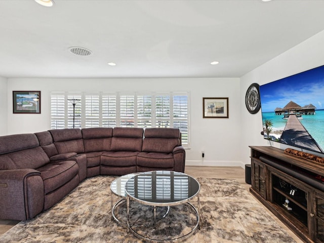 1666 N Dakota Ave NE, Saint Petersburg, FL 33703 - living room with baseboards, wood finished floors, and recessed lighting