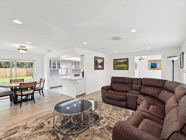 1666 N Dakota Ave NE, Saint Petersburg, FL 33703 - living area with baseboards, visible vents, recessed lighting, and light wood finished floors