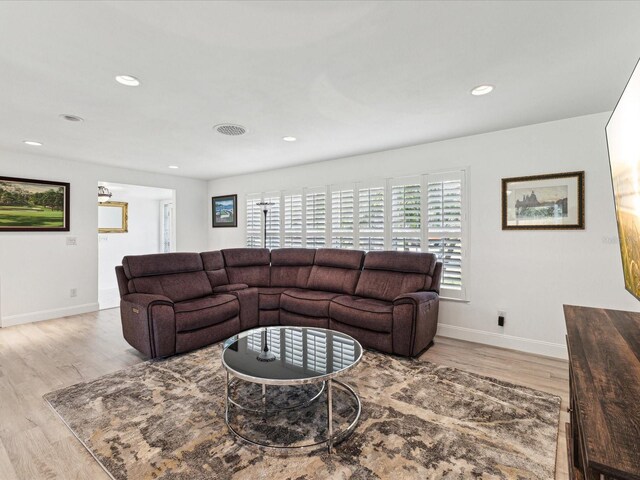 1666 N Dakota Ave NE, Saint Petersburg, FL 33703 - living room featuring a wealth of natural light, visible vents, wood finished floors, and baseboards