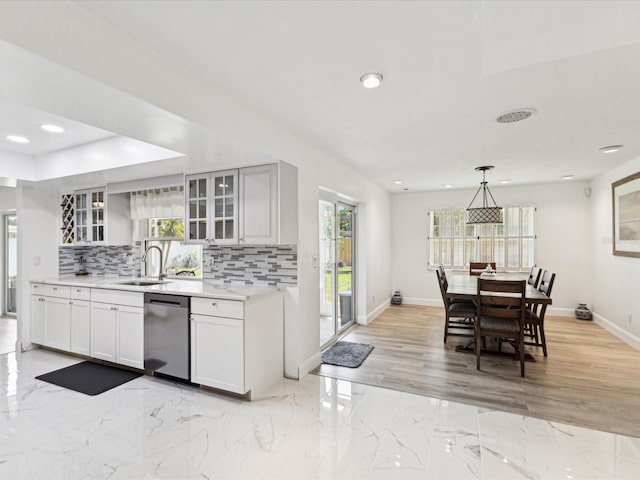 1666 N Dakota Ave NE, Saint Petersburg, FL 33703 - kitchen with backsplash, light countertops, a sink, and stainless steel dishwasher