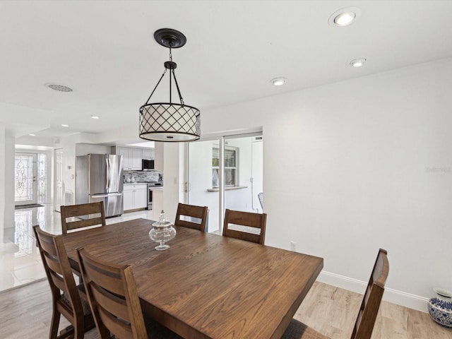 1666 N Dakota Ave NE, Saint Petersburg, FL 33703 - dining space featuring baseboards, light wood-style flooring, and recessed lighting