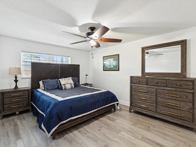 1666 N Dakota Ave NE, Saint Petersburg, FL 33703 - bedroom featuring baseboards, a textured ceiling, a ceiling fan, and light wood-type flooring